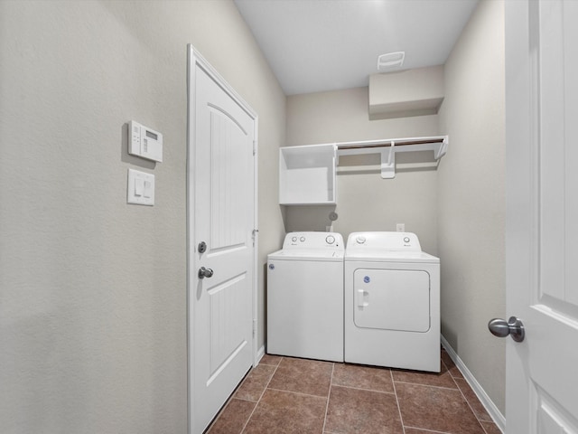 16020 Fountainview Dr Unit 21, Montgomery, TX 77356 - laundry room with washing machine and dryer and dark tile patterned floors