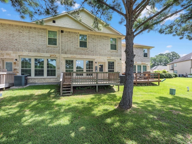 16020 Fountainview Dr Unit 21, Montgomery, TX 77356 - back of property with a wooden deck, a lawn, stone siding, and brick siding