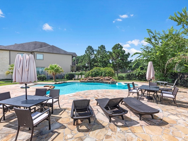 16020 Fountainview Dr Unit 21, Montgomery, TX 77356 - view of swimming pool featuring a patio, a fenced backyard, and outdoor dining space