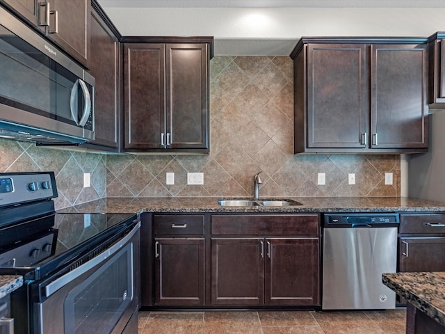 16020 Fountainview Dr Unit 21, Montgomery, TX 77356 - kitchen with appliances with stainless steel finishes, dark stone counters, dark brown cabinets, and backsplash