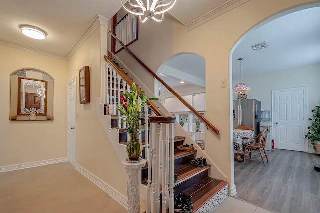 1407 Ella Cir, Houston, TX 77090 - staircase with arched walkways, ornamental molding, and a chandelier
