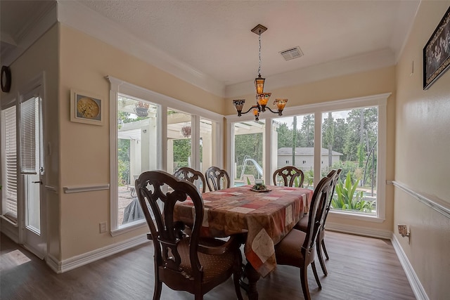 1407 Ella Cir, Houston, TX 77090 - dining room with a chandelier, wood finished floors, healthy amount of natural light, and crown molding