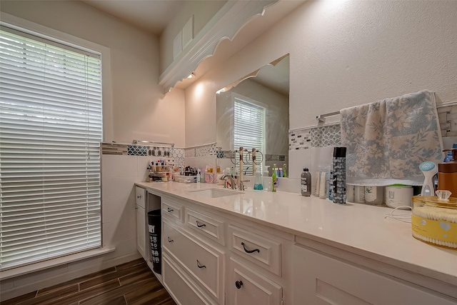 1407 Ella Cir, Houston, TX 77090 - bathroom with vanity, wood finished floors, tile walls, and wainscoting