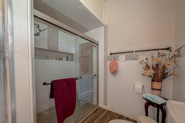 1407 Ella Cir, Houston, TX 77090 - bathroom featuring tile walls, a shower stall, and wood finished floors
