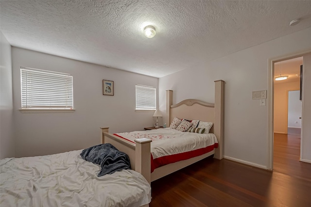 1407 Ella Cir, Houston, TX 77090 - bedroom featuring wood finished floors and a textured ceiling