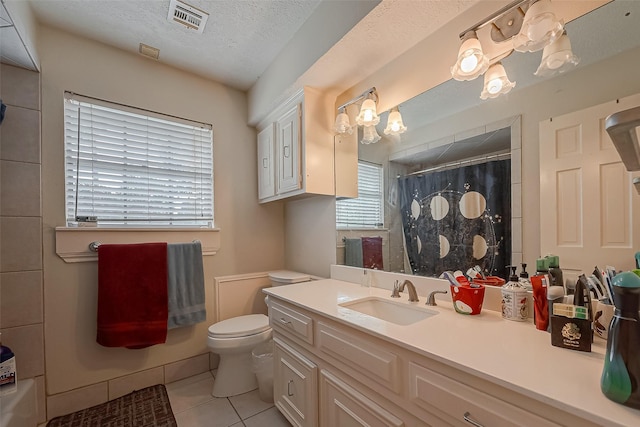 1407 Ella Cir, Houston, TX 77090 - bathroom featuring tile patterned floors, a textured ceiling, a shower with shower curtain, and vanity
