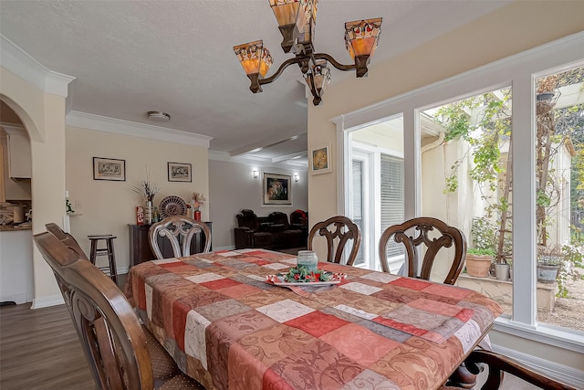 1407 Ella Cir, Houston, TX 77090 - dining area with wood finished floors, ornamental molding, arched walkways, and a chandelier