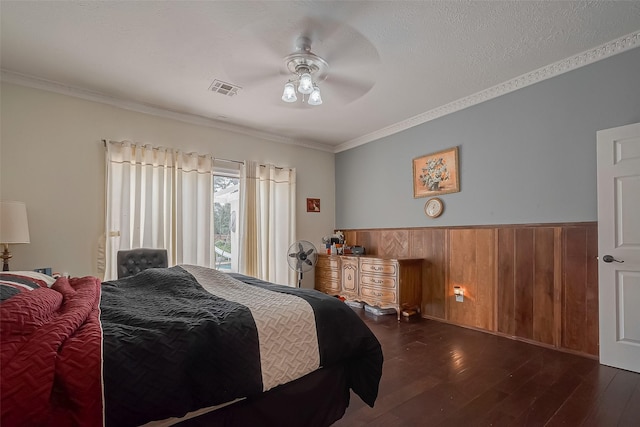 1407 Ella Cir, Houston, TX 77090 - bedroom featuring dark wood finished floors, crown molding, wooden walls, access to exterior, and a wainscoted wall