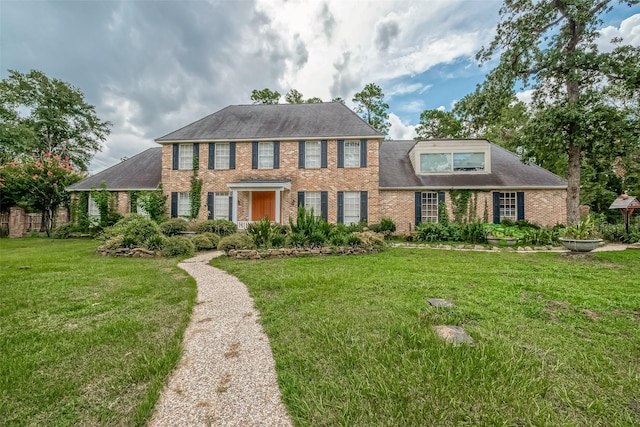 1407 Ella Cir, Houston, TX 77090 - view of front of house featuring brick siding, a front lawn, and roof with shingles