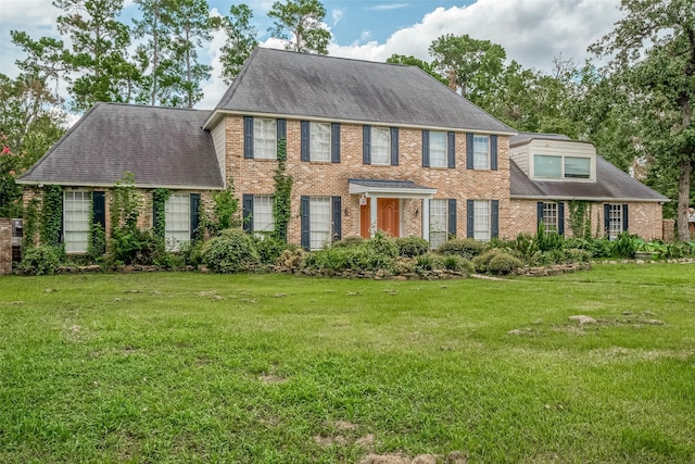 1407 Ella Cir, Houston, TX 77090 - view of front of house with brick siding, a front lawn, and roof with shingles