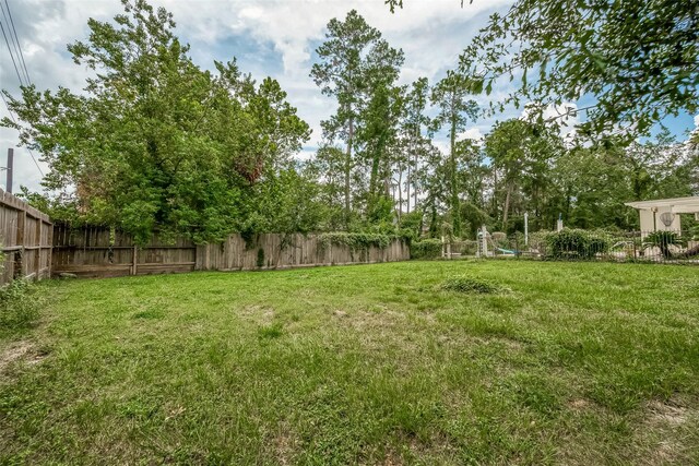 1407 Ella Cir, Houston, TX 77090 - fenced backyard with a playground