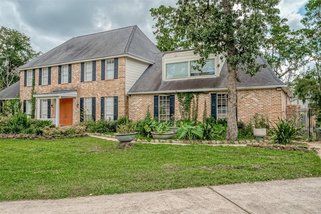 1407 Ella Cir, Houston, TX 77090 - view of front of home featuring brick siding, a front yard, and roof with shingles