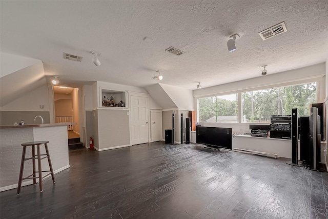 1407 Ella Cir, Houston, TX 77090 - living room with dark wood-style flooring and a textured ceiling