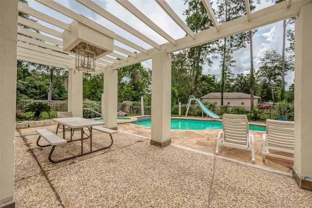1407 Ella Cir, Houston, TX 77090 - view of pool with a water slide, a pergola, a fenced backyard, a patio, and a pool with connected hot tub