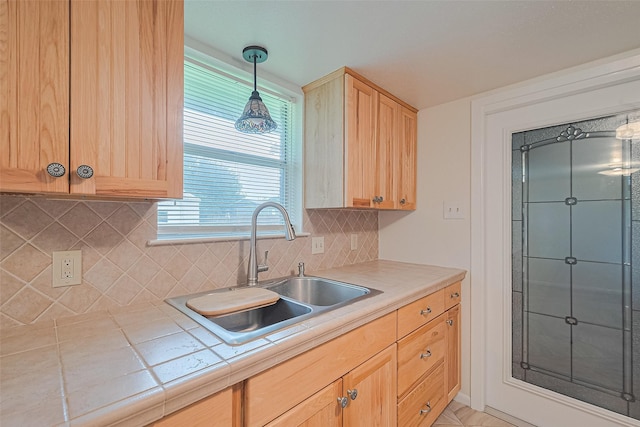 1640 Shepherd St, Hempstead, TX 77445 - kitchen featuring tile countertops, light brown cabinets, decorative backsplash, and decorative light fixtures