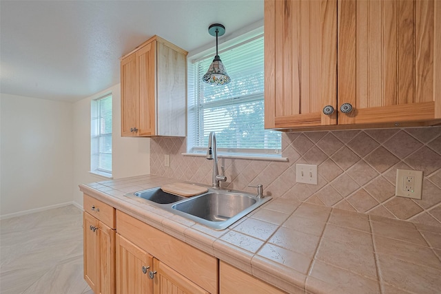 1640 Shepherd St, Hempstead, TX 77445 - kitchen featuring tile counters, light brown cabinets, tasteful backsplash, and decorative light fixtures