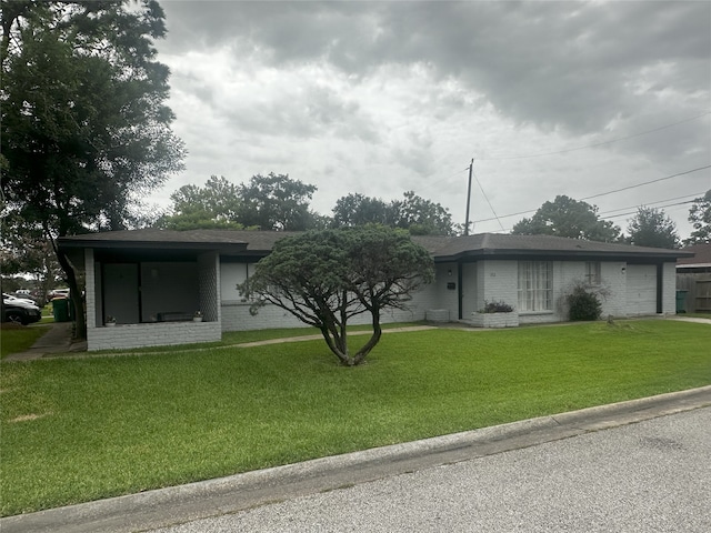 1773 El Mar Ln, Seabrook, TX 77586 - view of front facade with a garage, brick siding, a front lawn, and driveway