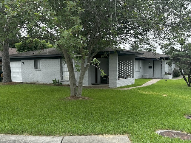 1773 El Mar Ln, Seabrook, TX 77586 - rear view of property featuring brick siding, a yard, and a shingled roof