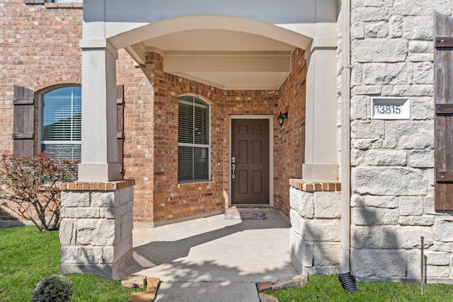 13815 Lake Livingston Dr, Houston, TX 77044 - view of exterior entry with brick siding and a porch
