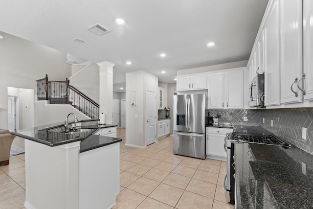 13815 Lake Livingston Dr, Houston, TX 77044 - kitchen with appliances with stainless steel finishes, backsplash, light tile patterned flooring, white cabinetry, and recessed lighting