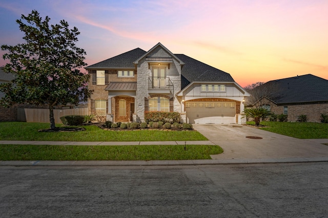 13815 Lake Livingston Dr, Houston, TX 77044 - french provincial home with stone siding, concrete driveway, a garage, roof with shingles, and a standing seam roof