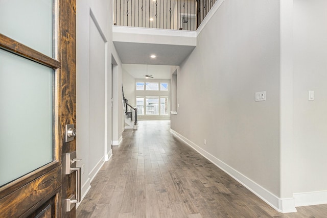 28622 Mountain Timber Ct, Fulshear, TX 77441 - foyer featuring stairs, wood finished floors, and a high ceiling