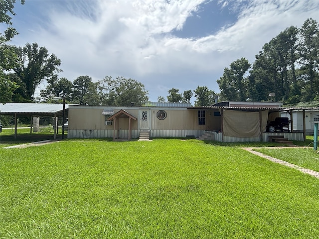 21061 Brazos Dr, New Caney, TX 77357 - view of front of home with entry steps, a carport, and a front yard
