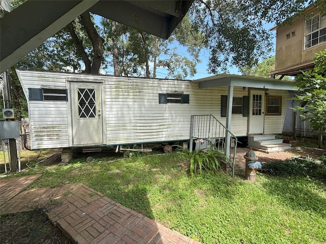 21061 Brazos Dr, New Caney, TX 77357 - back of property featuring a lawn