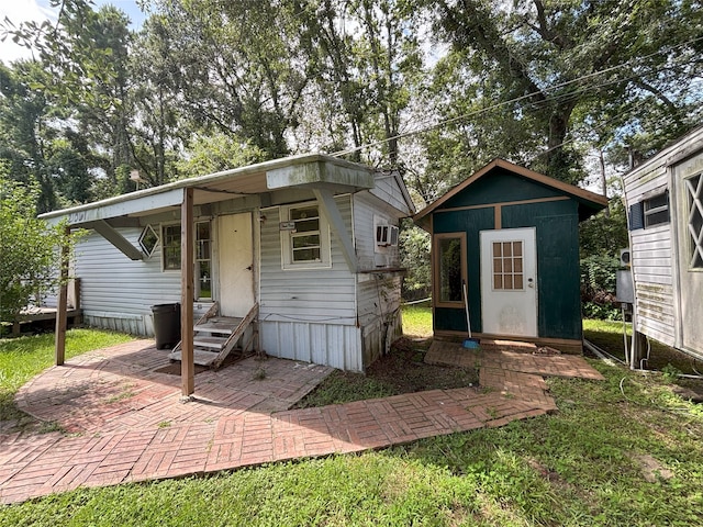 21061 Brazos Dr, New Caney, TX 77357 - view of front of property with entry steps and a storage unit