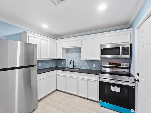 4418 Dacca Dr, Houston, TX 77047 - kitchen with appliances with stainless steel finishes, dark countertops, white cabinets, backsplash, and ornamental molding