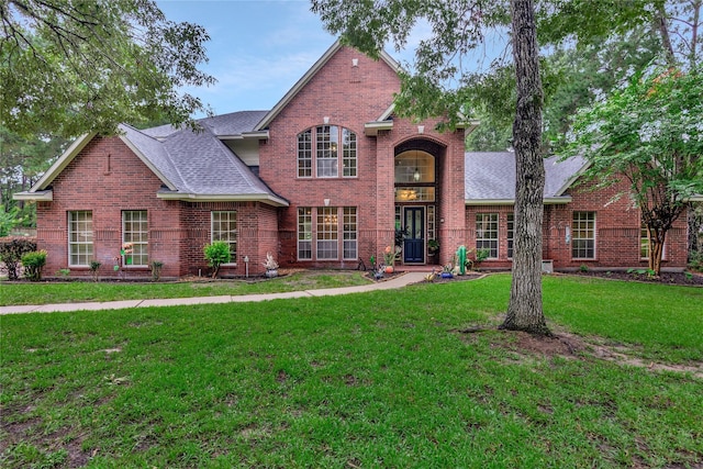 14419 Timbergreen Dr, Magnolia, TX 77355 - traditional-style home with brick siding, a front yard, and roof with shingles
