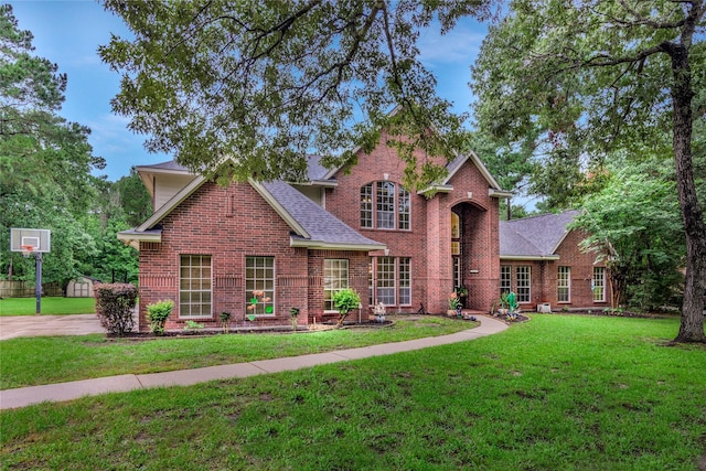 14419 Timbergreen Dr, Magnolia, TX 77355 - traditional-style house with brick siding, a front lawn, and roof with shingles