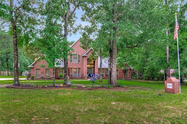 14419 Timbergreen Dr, Magnolia, TX 77355 - view of front facade featuring brick siding and a front yard