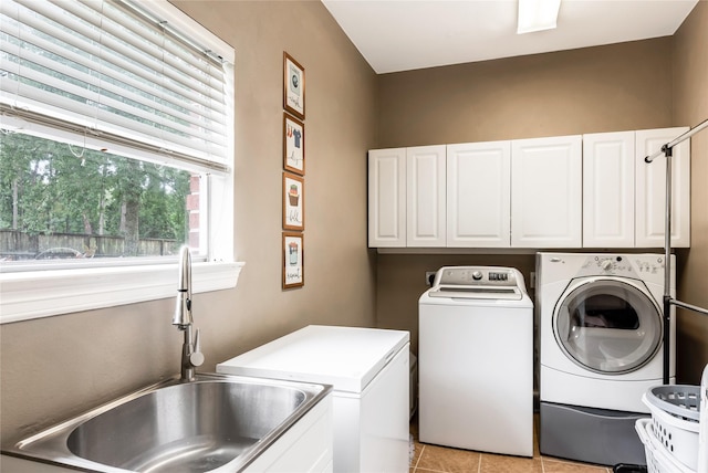 14419 Timbergreen Dr, Magnolia, TX 77355 - washroom featuring cabinet space, washing machine and dryer, and light tile patterned floors
