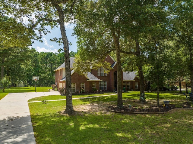 14419 Timbergreen Dr, Magnolia, TX 77355 - view of side of property featuring a yard, driveway, and brick siding