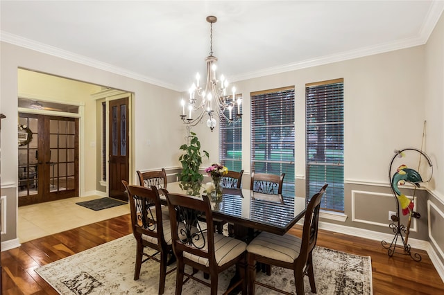 14419 Timbergreen Dr, Magnolia, TX 77355 - dining space with wood finished floors, a chandelier, crown molding, and french doors
