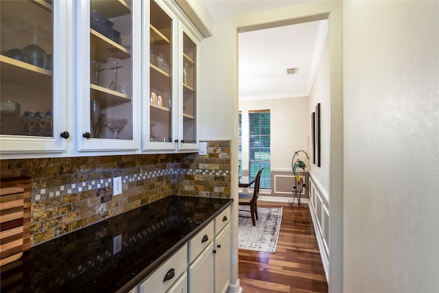 14419 Timbergreen Dr, Magnolia, TX 77355 - kitchen featuring crown molding, tasteful backsplash, glass insert cabinets, dark wood-style flooring, and white cabinets