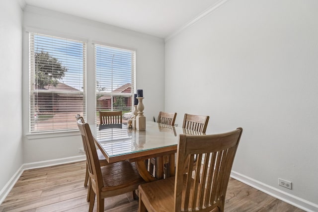 4003 Autumn Pines Trl, Houston, TX 77084 - dining area featuring crown molding, light wood-style flooring, and plenty of natural light