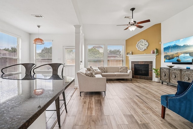 4003 Autumn Pines Trl, Houston, TX 77084 - living room featuring light wood-style flooring, a ceiling fan, plenty of natural light, a fireplace, and vaulted ceiling