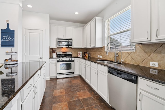 4003 Autumn Pines Trl, Houston, TX 77084 - kitchen featuring stainless steel appliances, white cabinetry, dark stone countertops, tasteful backsplash, and recessed lighting