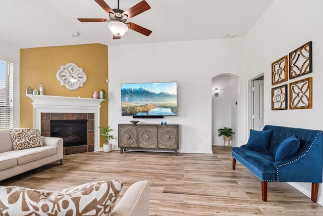 4003 Autumn Pines Trl, Houston, TX 77084 - living room featuring arched walkways, ceiling fan, wood finished floors, a fireplace, and lofted ceiling