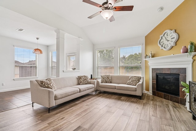 4003 Autumn Pines Trl, Houston, TX 77084 - living area with wood finished floors, ceiling fan, vaulted ceiling, and a tile fireplace