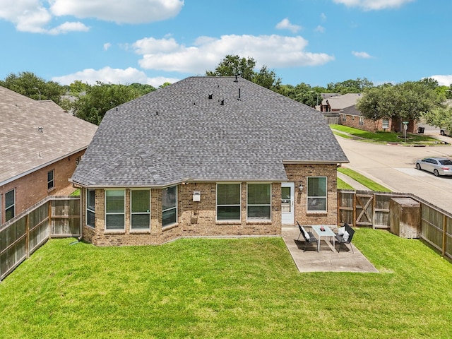 4003 Autumn Pines Trl, Houston, TX 77084 - back of property with a shingled roof, brick siding, a fenced backyard, and a patio