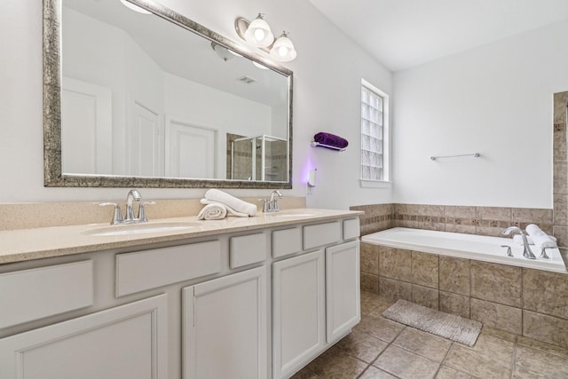 4003 Autumn Pines Trl, Houston, TX 77084 - full bath featuring double vanity, a shower stall, a garden tub, and tile patterned flooring