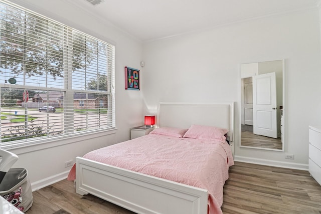 4003 Autumn Pines Trl, Houston, TX 77084 - bedroom featuring multiple windows, wood finished floors, and ornamental molding