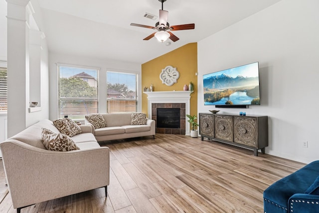 4003 Autumn Pines Trl, Houston, TX 77084 - living area featuring wood finished floors, lofted ceiling, ceiling fan, and a tiled fireplace