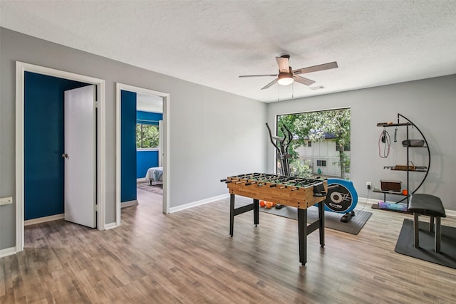 5210 Creek Shadows Dr, Houston, TX 77339 - game room featuring a ceiling fan, wood finished floors, and a textured ceiling