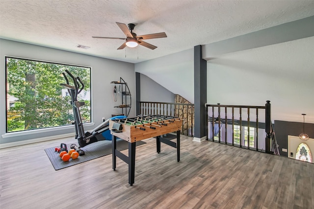 5210 Creek Shadows Dr, Houston, TX 77339 - playroom featuring ceiling fan, wood finished floors, and a textured ceiling