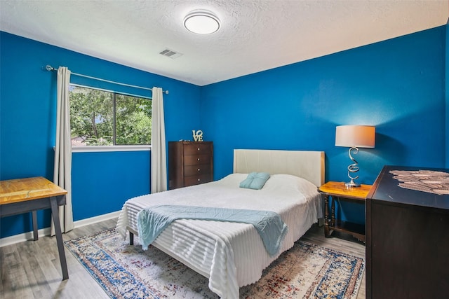 5210 Creek Shadows Dr, Houston, TX 77339 - bedroom with a textured ceiling and wood finished floors