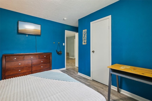 5210 Creek Shadows Dr, Houston, TX 77339 - bedroom with wood finished floors and a textured ceiling